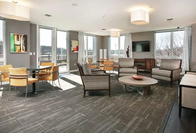 Bright common area with comfortable seating and art