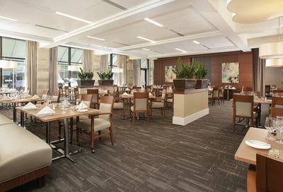 Elegant dining room setup with tables and plants