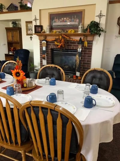 Dining table set for a meal in a cozy common area
