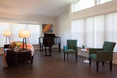Bright interior common area with a piano
