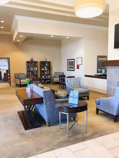 Bright interior common area with seating and bookshelves