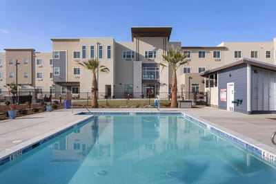 Outdoor pool area with building in the background