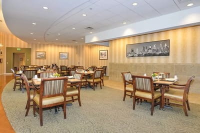 Bright dining room with table settings and artwork on the walls