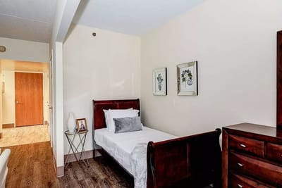 Interior view of a resident room with a bed and decor