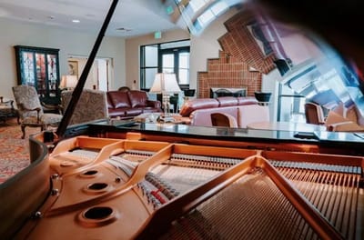 Interior view of a common area with a piano and seating