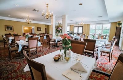 Elegant dining room setup with tables and flowers