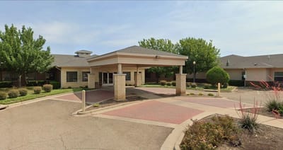 Exterior view of nursing home entrance with landscaping
