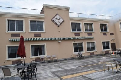 Exterior view of a senior facility with outdoor seating areas