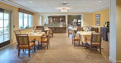 Dining area with tables and chairs set for a meal