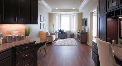Bright interior of a resident suite with a living area and kitchenette