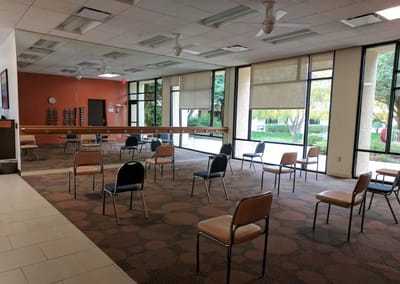 Interior common area with chairs arranged for social distancing