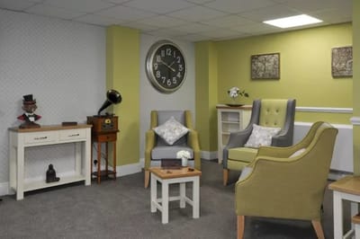 Cozy common area with chairs and a vintage clock