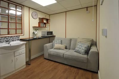 Cozy common area with a couch and small kitchenette