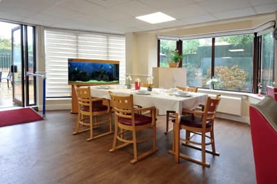 Dining area with tables and an aquarium