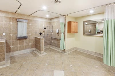 Accessible bathroom with grab bars and tiled floors