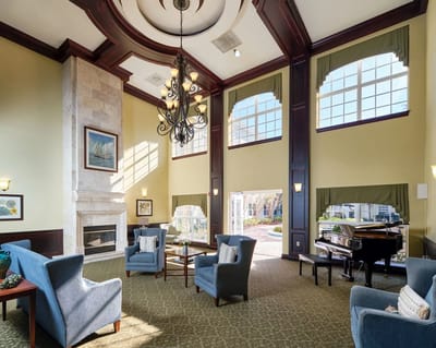 Bright and welcoming common area with seating and a piano