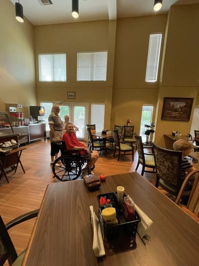 Residents interacting in a bright dining room