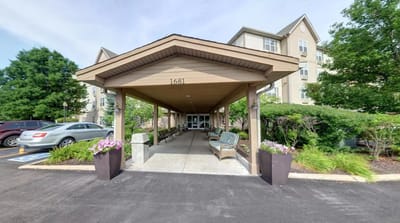 Covered entrance with seating and flowers at Willow Falls