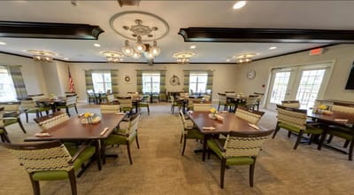 Dining room with tables and chairs set for residents