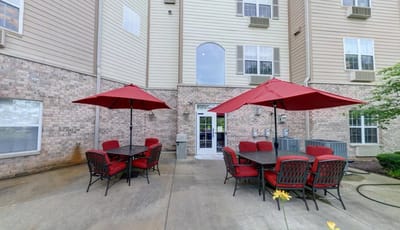 Outdoor seating area with red umbrellas and tables
