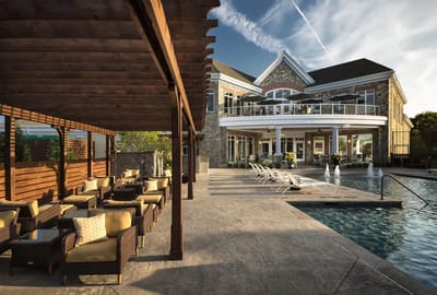 Outdoor pool area with seating and building facade