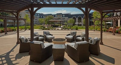 Outdoor seating area with a gazebo and greenery