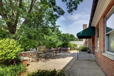 Outdoor patio area with seating and greenery