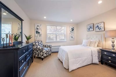 A well-furnished resident room with natural light