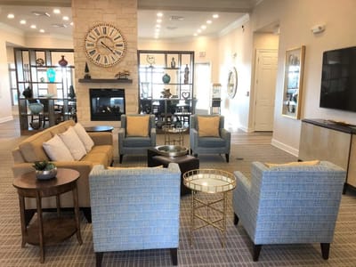 Common area with seating and fireplace in a senior living facility