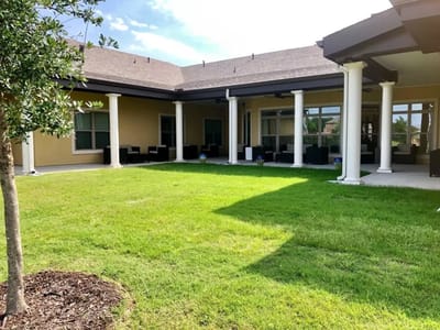 Outdoor space with seating area and grass lawn