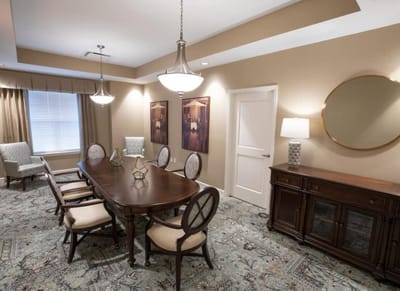 Bright common area with dining table and chairs