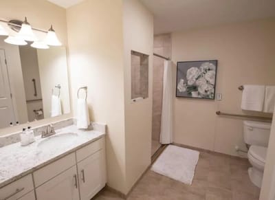Clean bathroom with floral decor and amenities