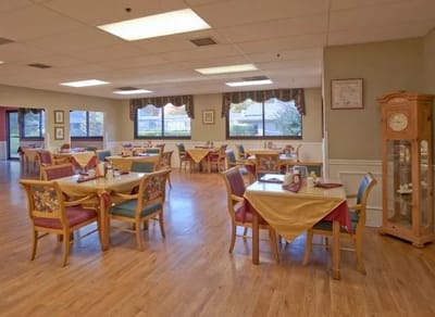 Dining area with tables and chairs set for meals