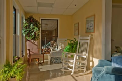 Bright common area with rocking chairs and plants