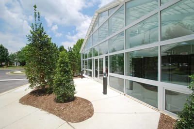 Exterior view of a modern entrance with greenery