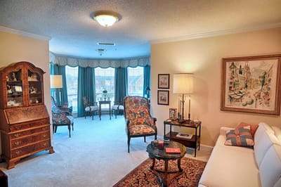 Cozy living room in a senior care facility with floral furniture