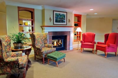 Cozy common area with floral patterned furniture and a fireplace