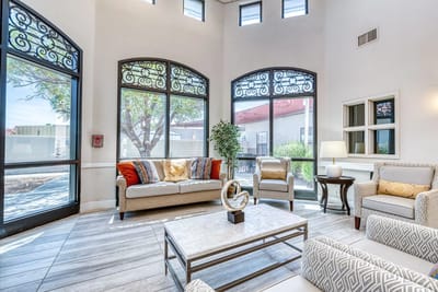 Bright common area with comfortable seating and large windows