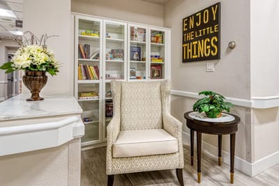 Cozy common area with a chair and bookshelf