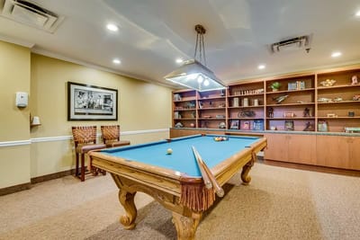Residents enjoying a game of billiards in a common area