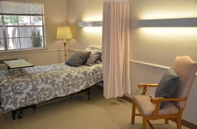 Private resident room with bed and chair