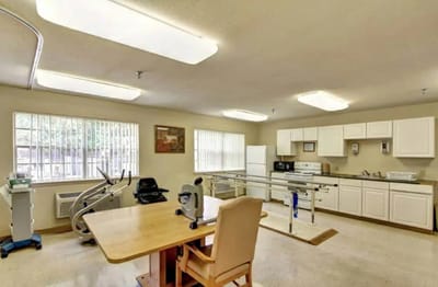 Bright therapy room with equipment and a table