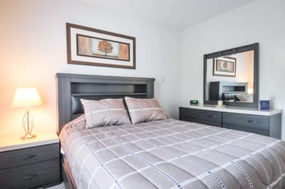 Private bedroom with a bed, dresser, and decor