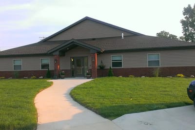 Exterior view of Allay Senior Care building with landscaping