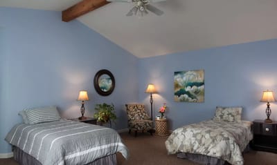 Bright interior of a resident room with two beds