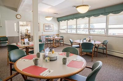 Dining room setup with tables and chairs