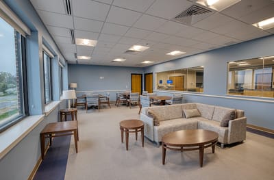Bright common area with comfortable seating and tables