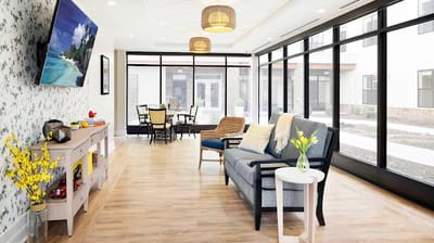 Bright common area with seating and large windows
