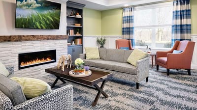 Bright common area with seating and a fireplace
