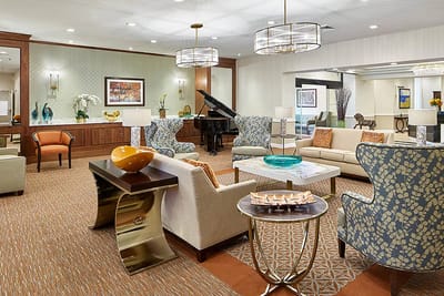 Bright common area with comfortable seating and piano